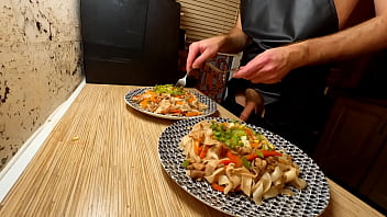 Beautiful cooking. Bare faggot chef is cooking rice noodle with chicken and vegetables